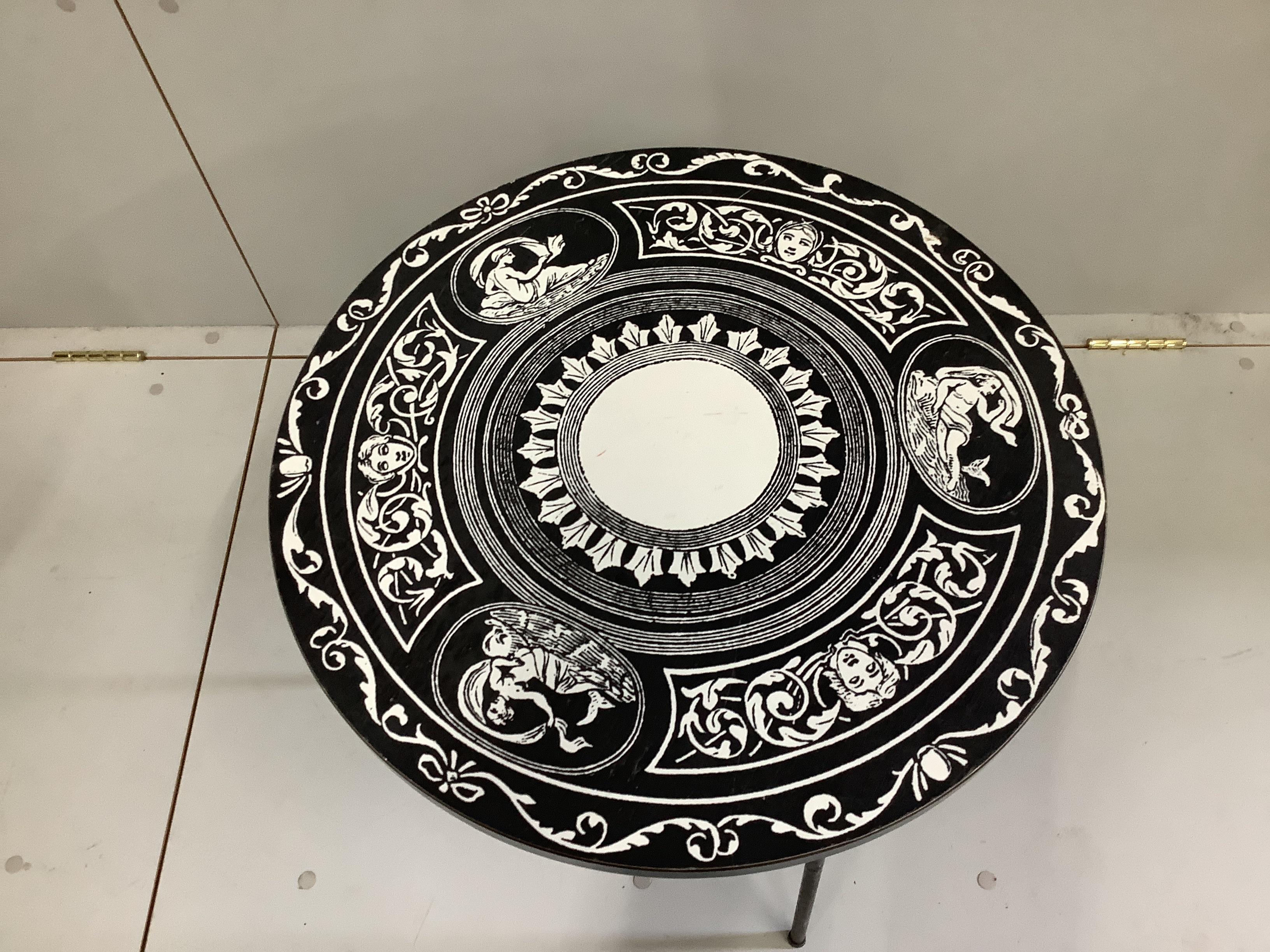 A Fornasetti style occasional table, diameter 52cm, height 48cm, together with a late 19th century Flemish carved side chair